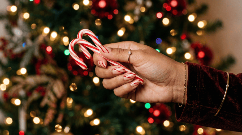 candy cane nails with thin elegant red stripes on nude base adult design